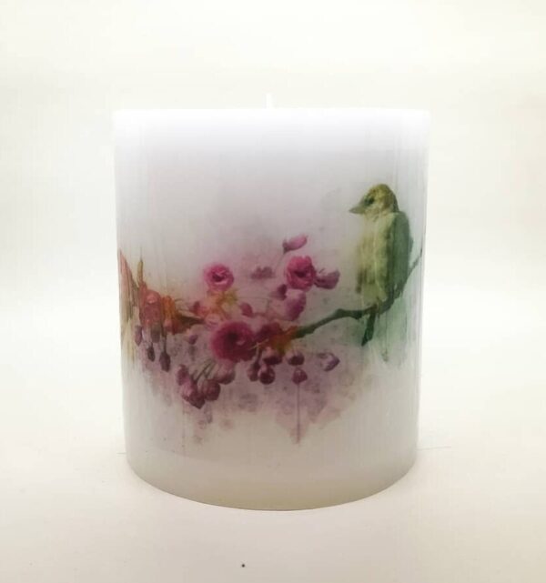 Pillar candle with a Bird on a branch picture.
