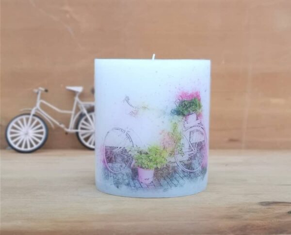 Pillar candle with a picture of Bike and Flowers.