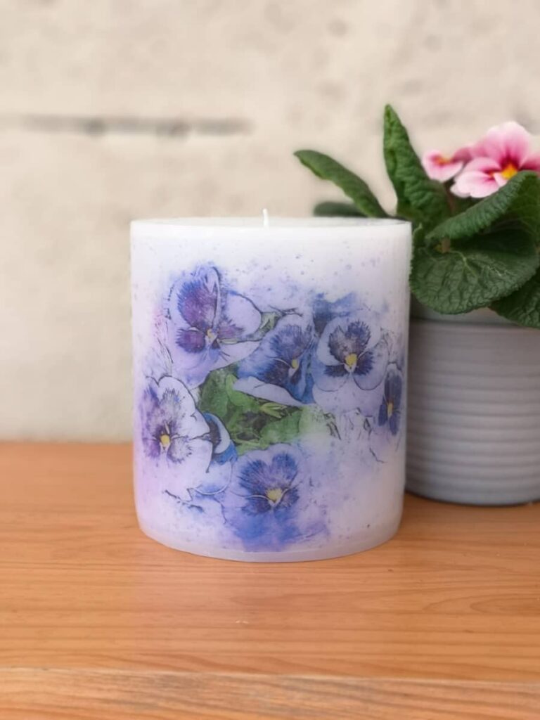 Pillar candle with a picture of Blue Pansies.