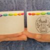 Set of two small wax lanterns both decorated with coloured wooden beads and 'thank you' print on one of them.
