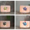 Four small wax lanterns with different colour Fimo beads