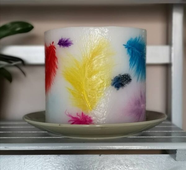 Wax lantern with coloured feathers.