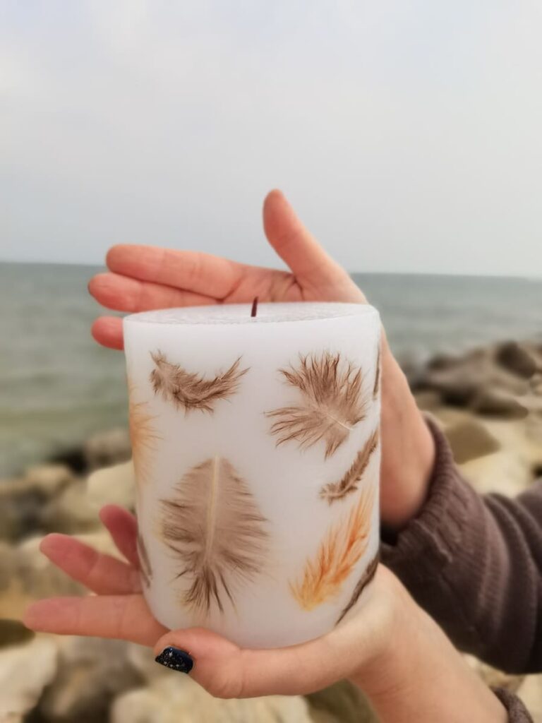 Candle with real natural feathers