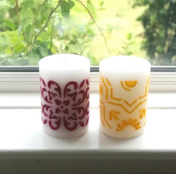 Two hand-carved candles.