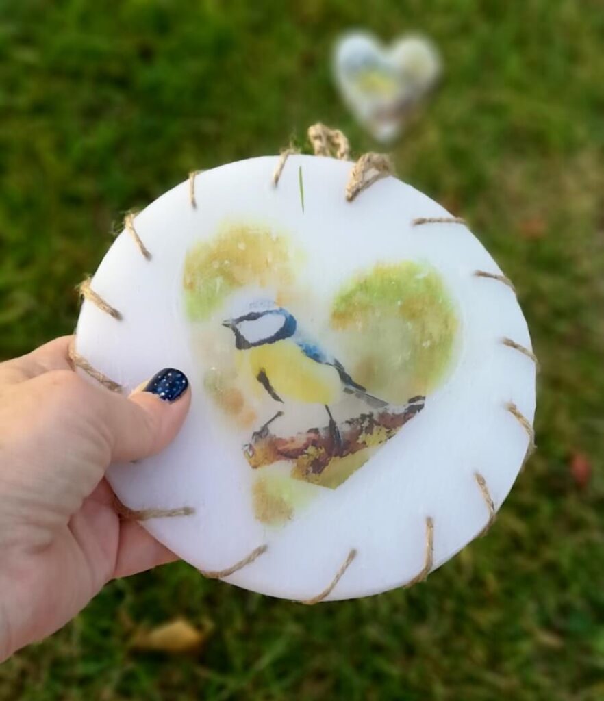 Round wax wall decoration with image of Blue Tit