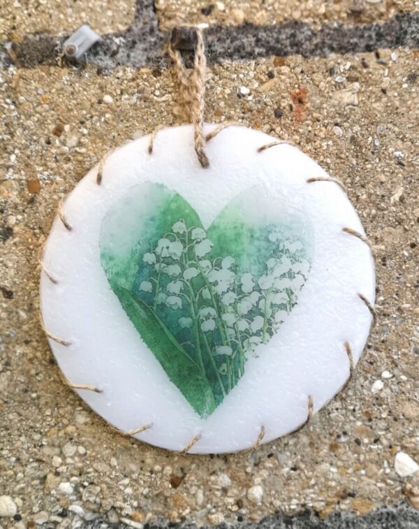 Wax ornament with a picture of Lily of the Valley.