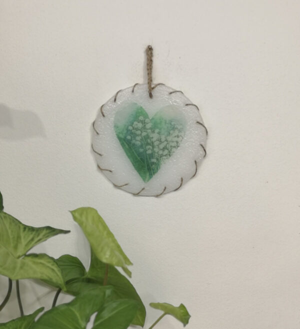 Wax ornament with a picture of Lily of the Valley.