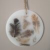 Wax ornament with natural feathers.