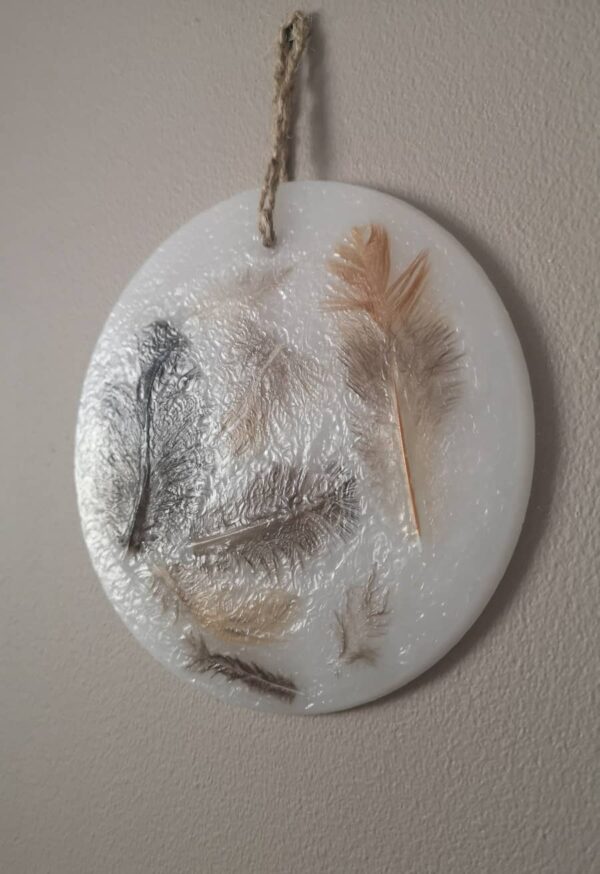 Wax ornament with real natural feathers.