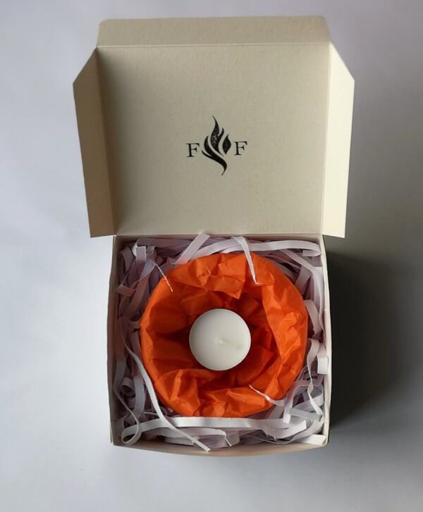 A small wax lantern in a white branded box.