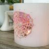 Wax lantern with pink crochet doilies, decorated with tiny beads.