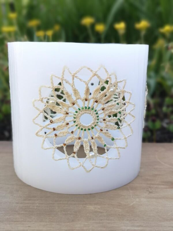 Wax lantern with ivory crochet doilies, embroidered with tiny beads.