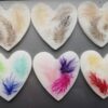 Fridge magnets with coloured and natural feathers.