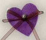Wax ornament with a purple heart shaped pocket.