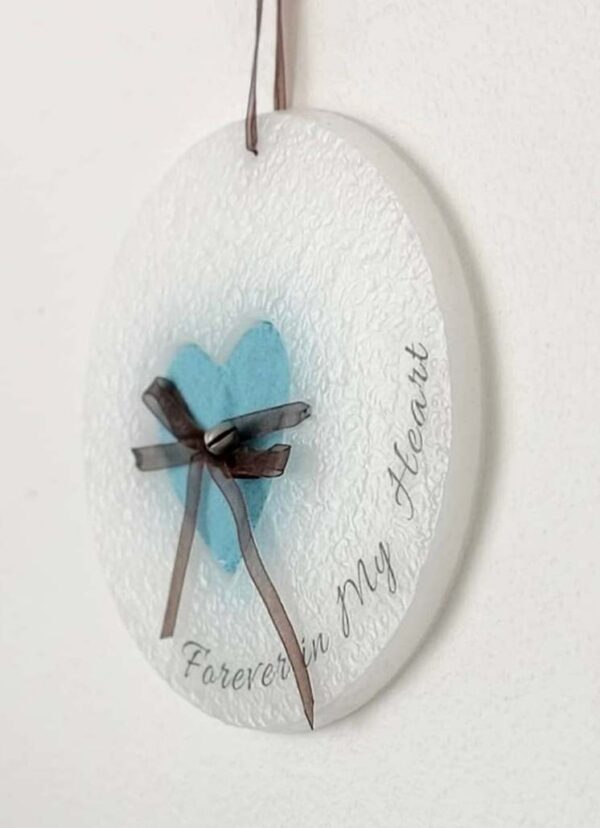 Wax ornament with a blue heart shaped pocket.