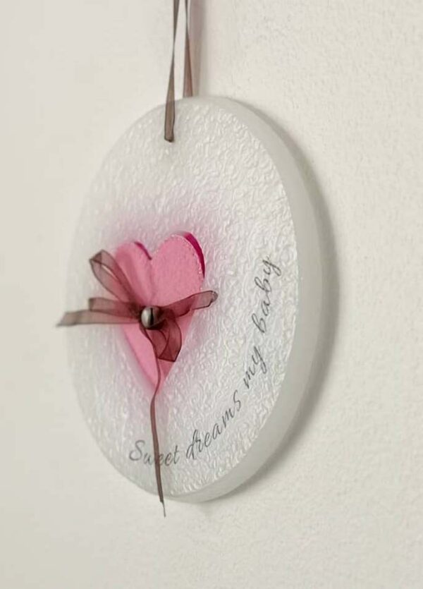 Wax ornament with a pink heart shaped pocket.