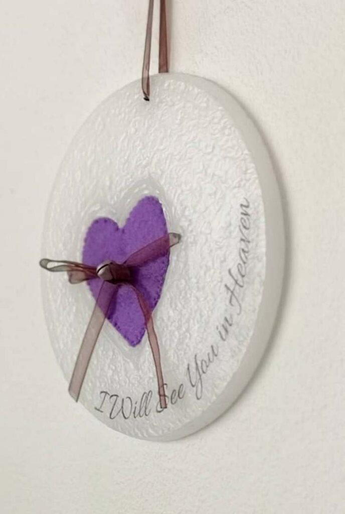 Wax ornament with a purple heart shaped pocket.
