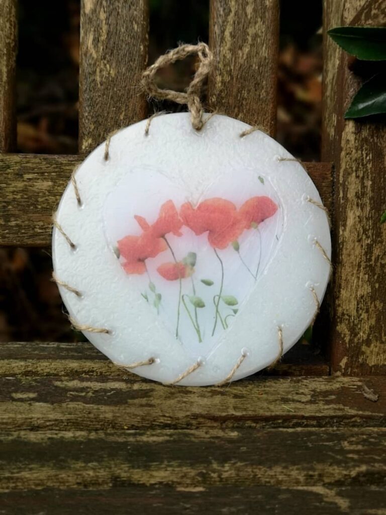Wax ornament with an image of Poppies.
