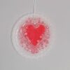 Wax ornament with a felt heart and swirls
