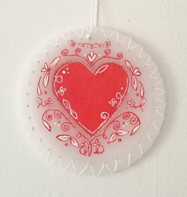 Wax ornament with a felt heart and swirls