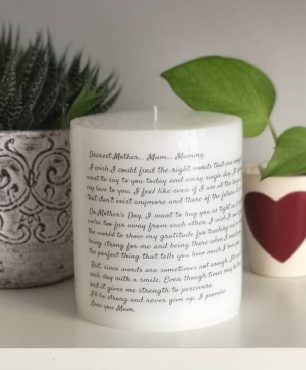 Big pillar candle with long text on it.