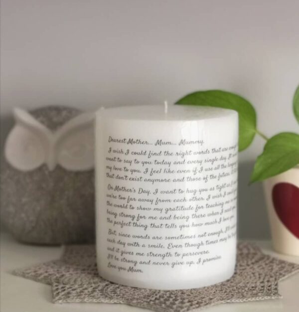 Big pillar candle with long text on it.