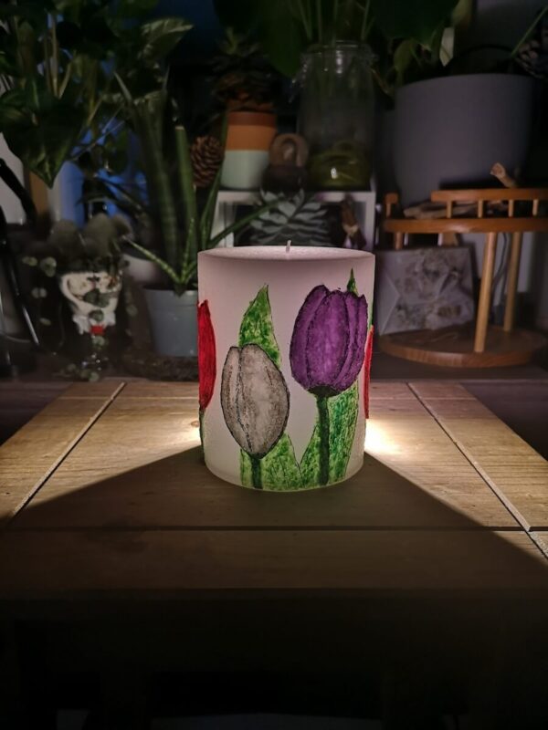 Large pillar candle with felt tulips.