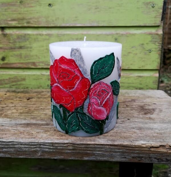 Large pillar candle with felt roses.