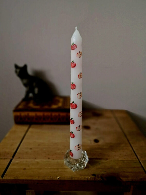 The one of 3 taper candles with apple pattern.