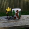 Large pillar candle with felt conkers and acorns.