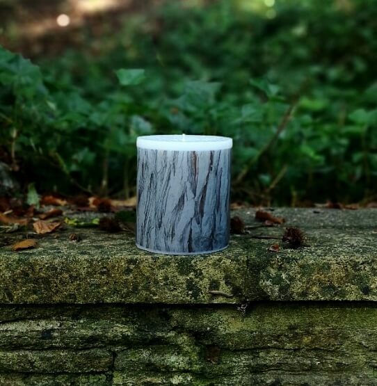 Large candle with printed Cedar bark tree pattern.