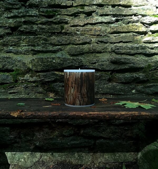 Large candle with printed Redwood bark tree pattern.