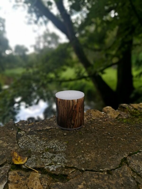 Large candle with printed Redwood bark tree pattern.