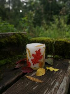 Large pillar candle with felt leaves.