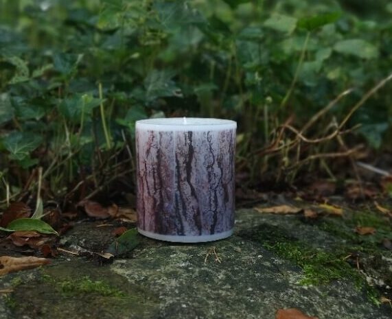 Large candle with printed Pine bark tree pattern.