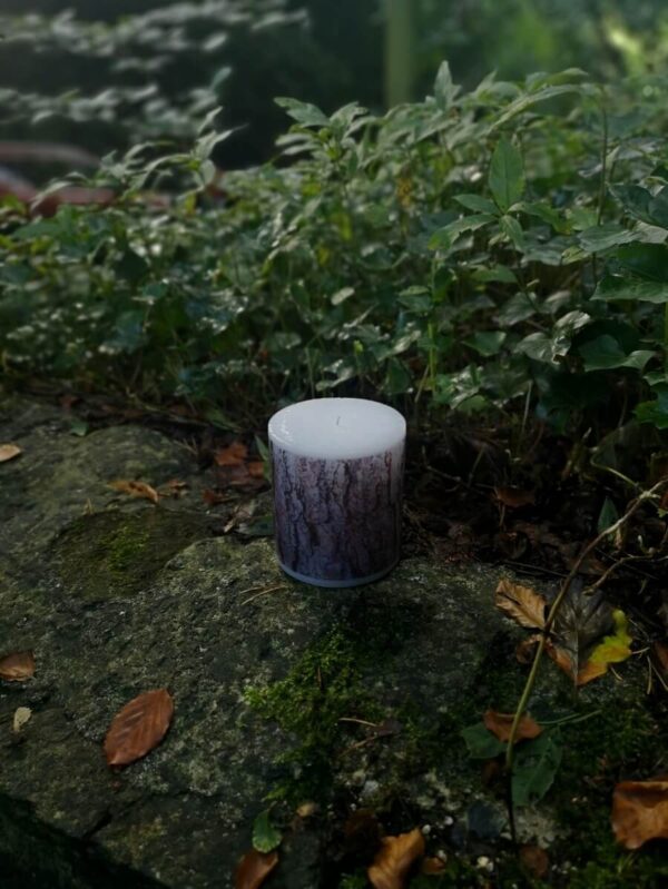 Large candle with printed Pine bark tree pattern.