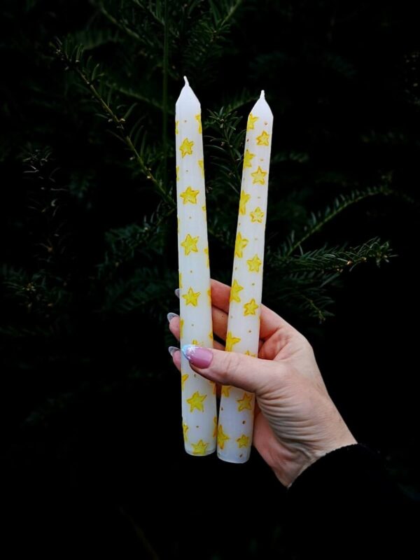 Festive taper candle with stars pattern.