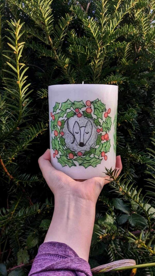 Pillar festive candle with a sleeping badger image.